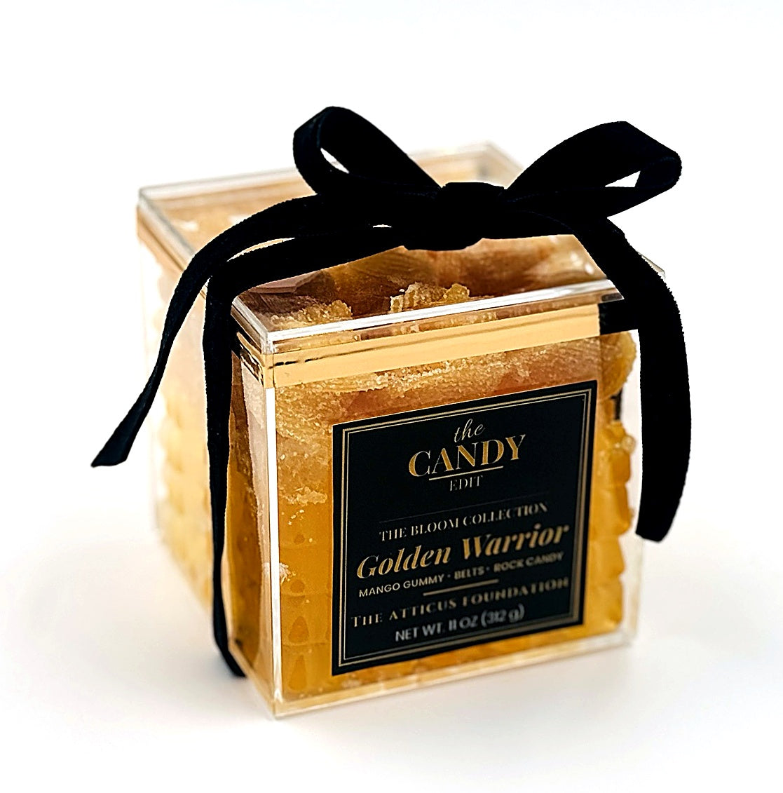 The Candy Edit Golden Warrior candy cube, three-quarter angle with black ribbon bow