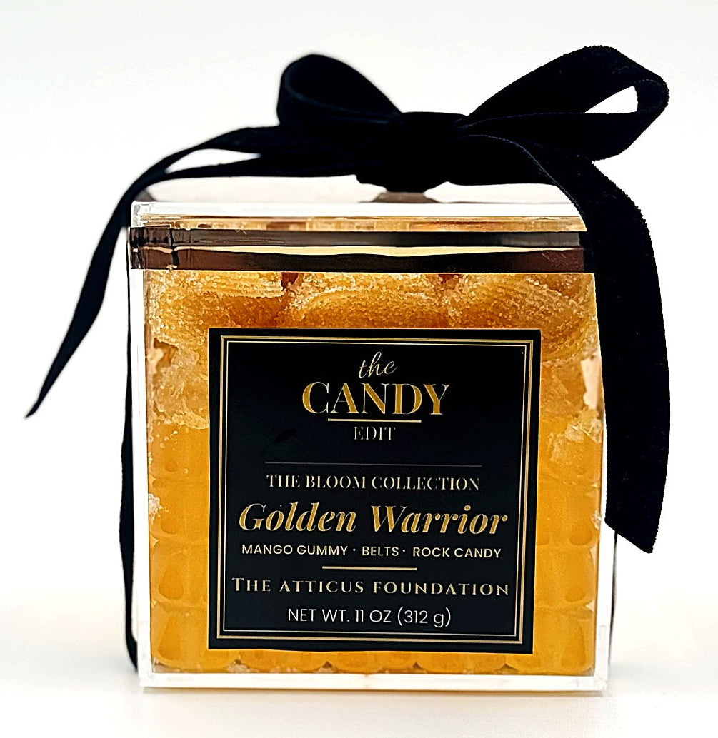 The Candy Edit Golden Warrior candy cube, front view with black velvet ribbon